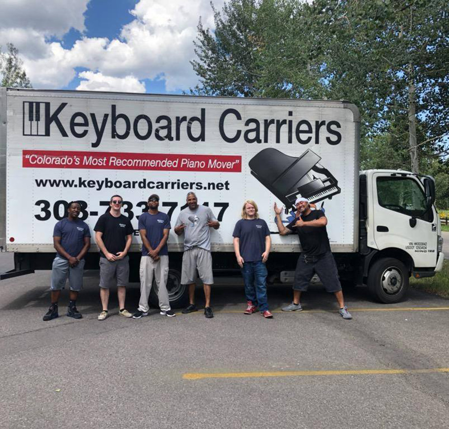 Keyboard Carriers crew standing in front of a branded truck in Denver